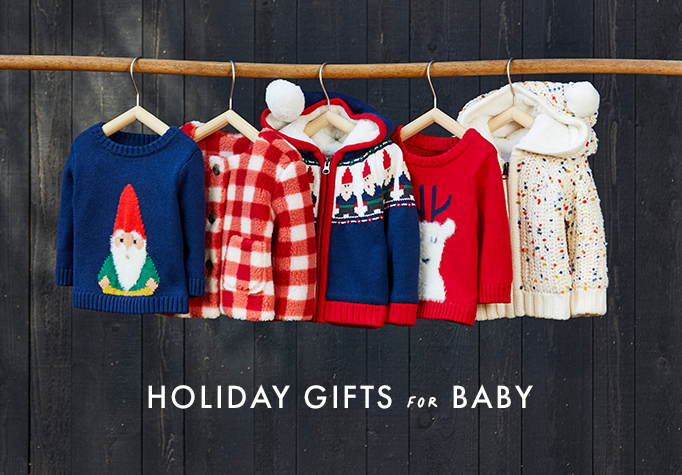 baby holiday clothes hanging on clothes hangers